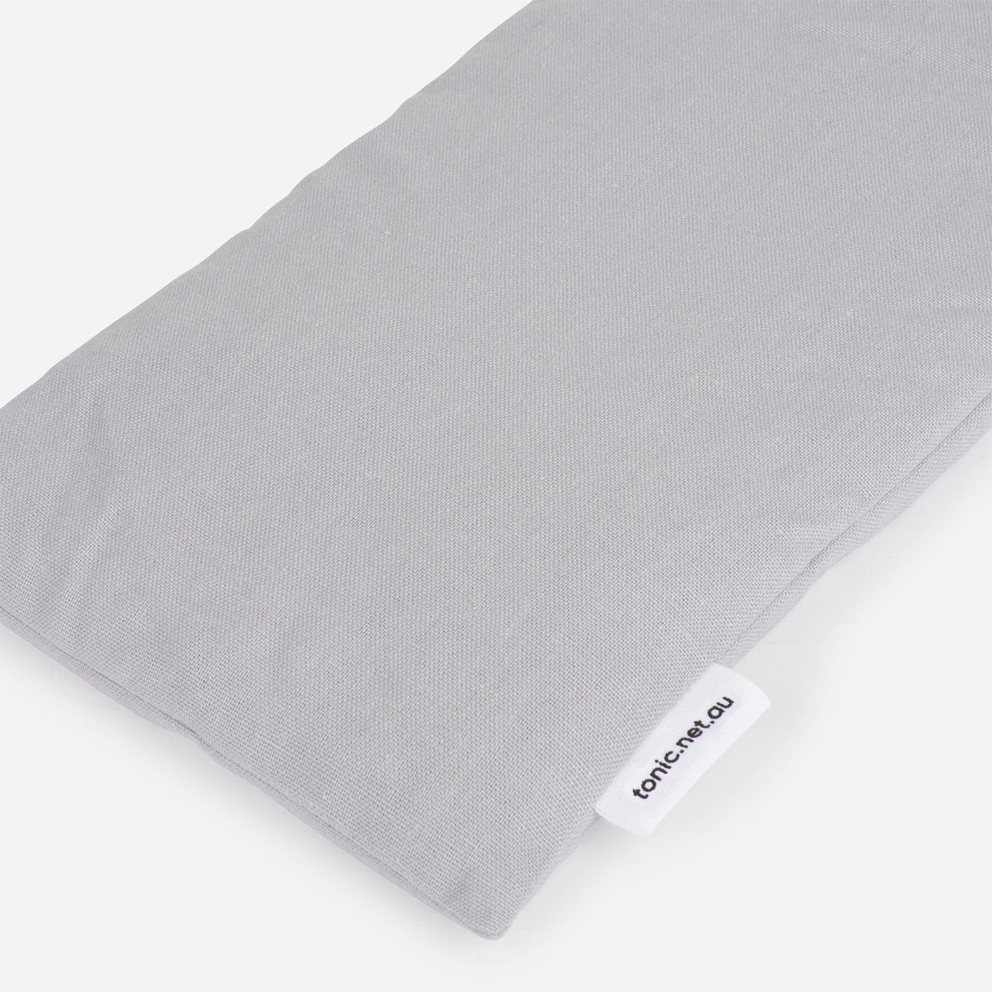 Grey Linen Heat pillow with a visible brand label on a white background